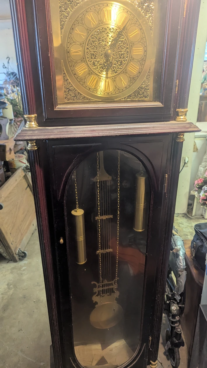 Grandfather clock with brass face and weights, from the Angotti Estate listing