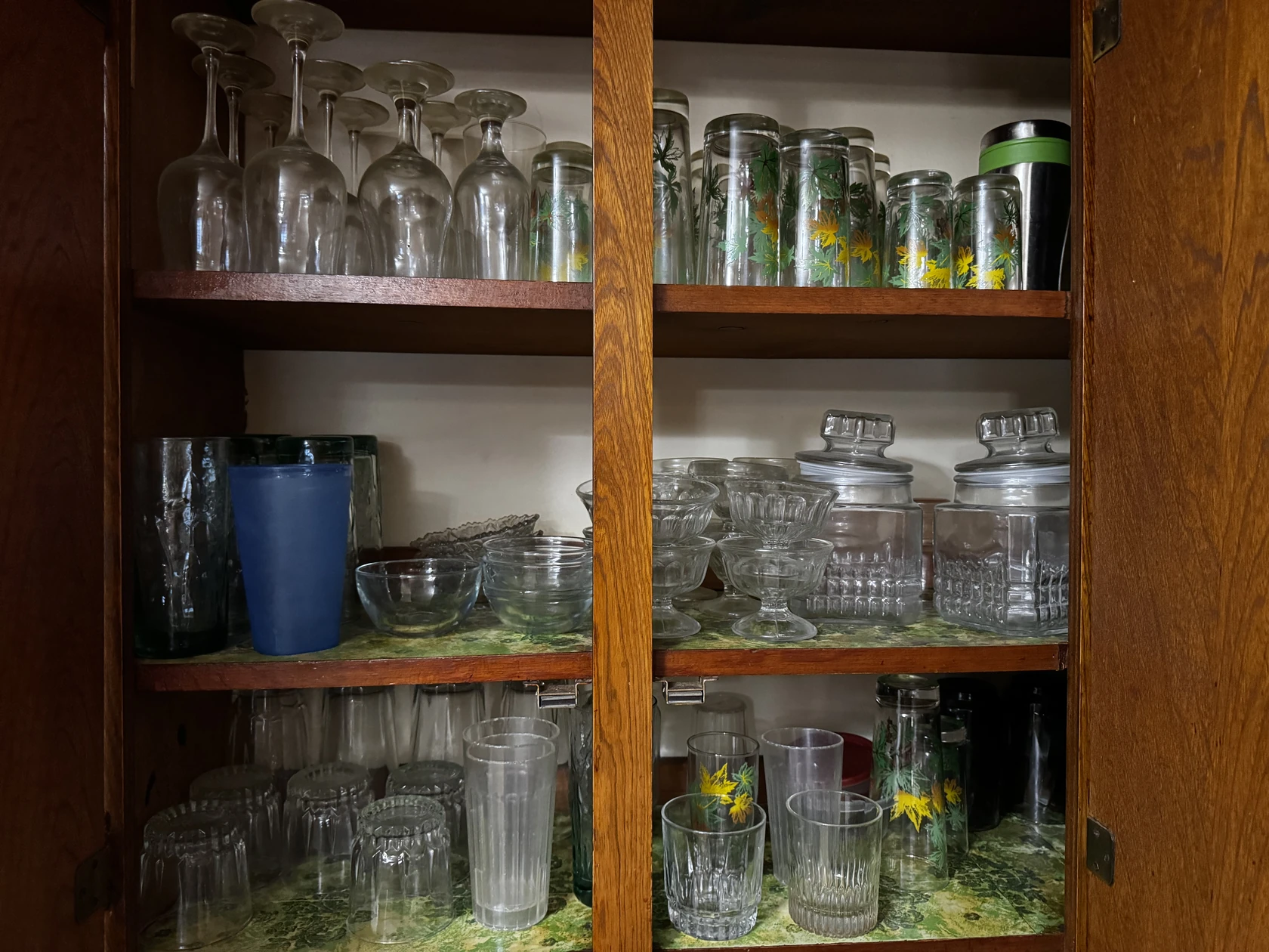 Glassware arranged in a wooden cabinet