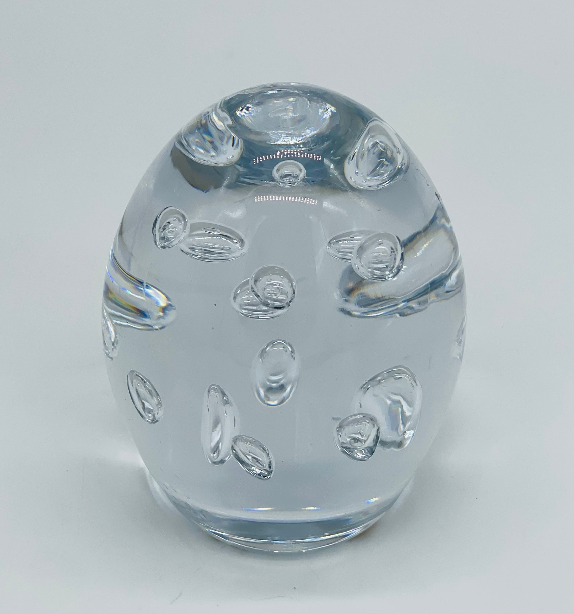 Clear art glass paperweight with bubble inclusions, front view